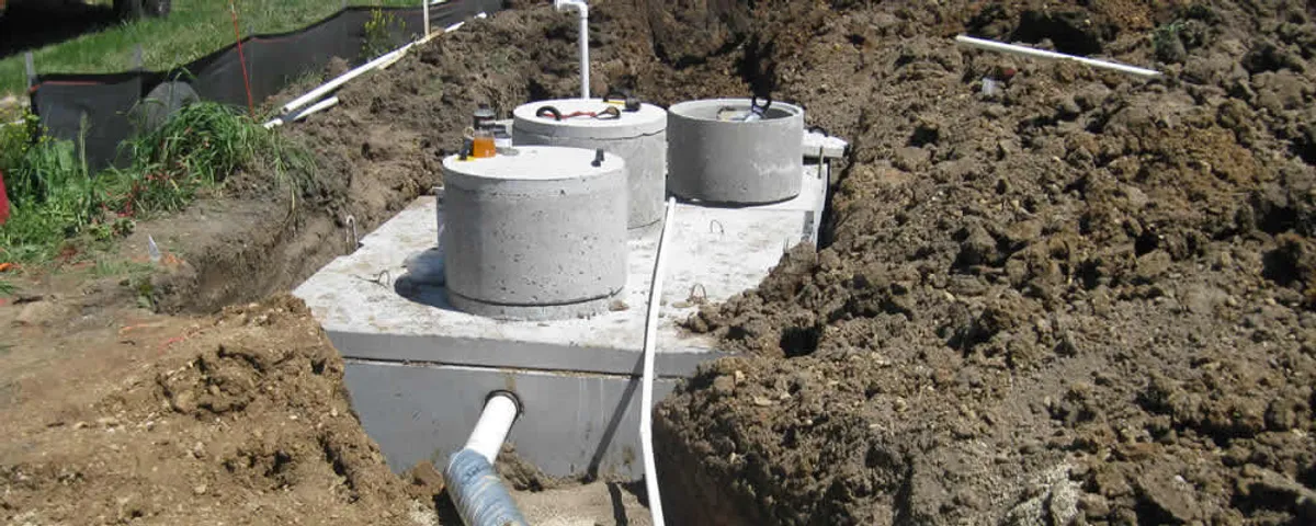 Septic system repair and installation site with tank access ports in Andover, MA