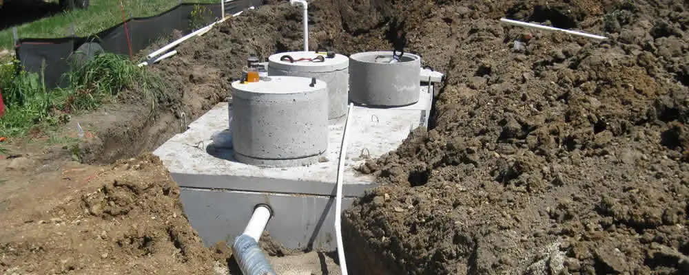Septic system repair and installation site with tank access ports in Andover, MA