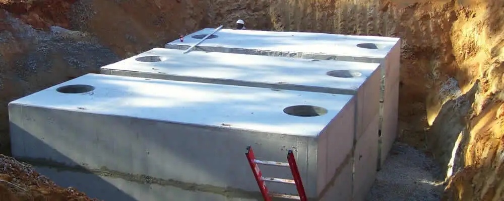 Septic tank installation site with a newly placed concrete tank in Andover, MA